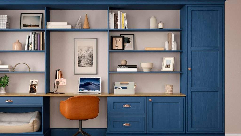 Blue Home Office Custom Shelving Unit With Shelves, Draws And Cabinets With A Complimentary Orange Chair.