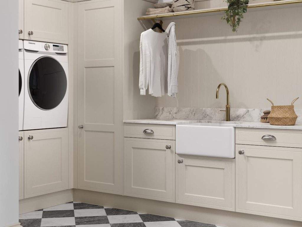 Utility Room With Beige Cabinets And Marble Worktops.